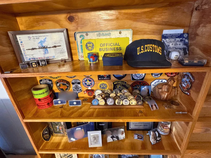 Before deep cleaning - Awards shelf with police badges and memorabilia